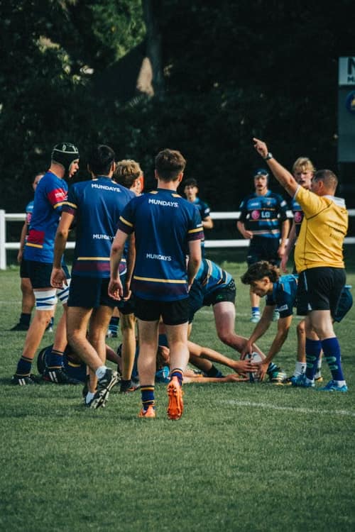A company team running together in matching kit during a group training session