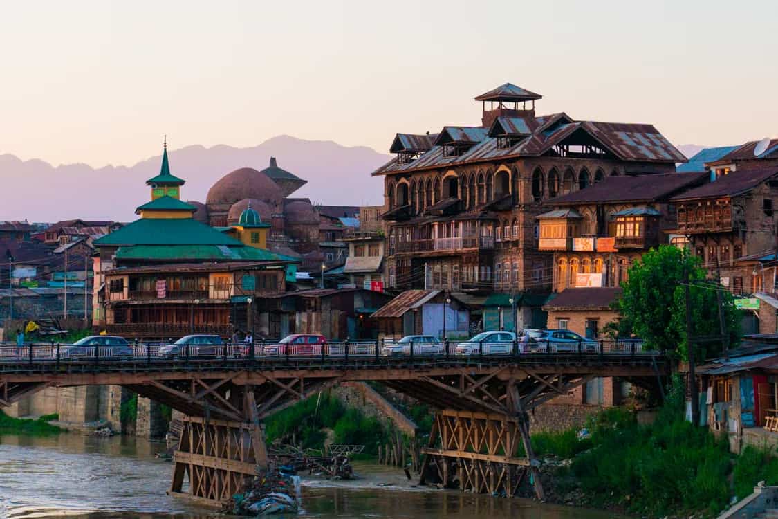 A Srinagar hotel exterior at street level, representing the Runner Essential package
