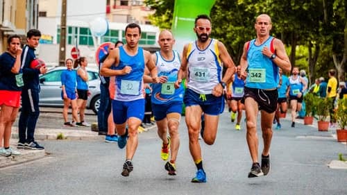 A running club gathered together in club singlets before a group training run